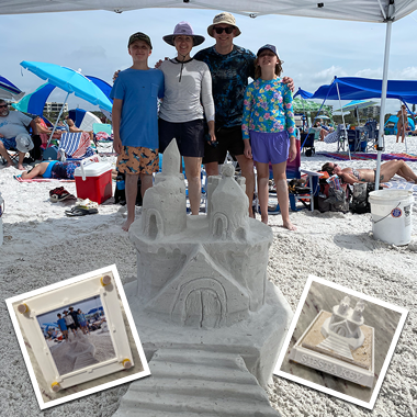 Family with a tall detailed sandcastle on Siesta Key Beach